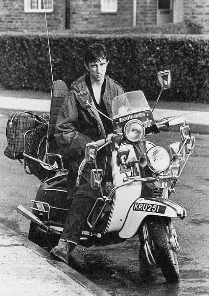 Young man on a vintage scooter, showcasing lesser-known historical fashion and transport styles.