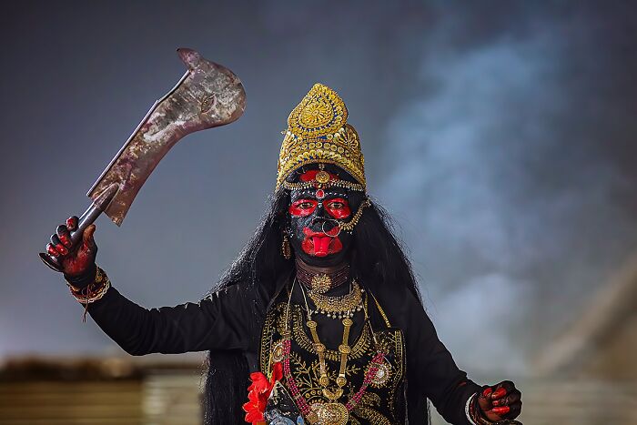 Person in traditional costume and makeup, showcasing cultural heritage and ethnicity.
