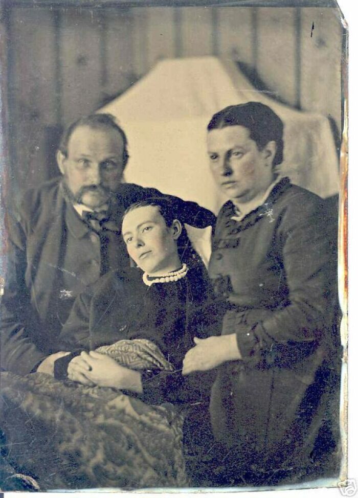 Victorian family portrait with somber expressions, part of creepy photos collection.