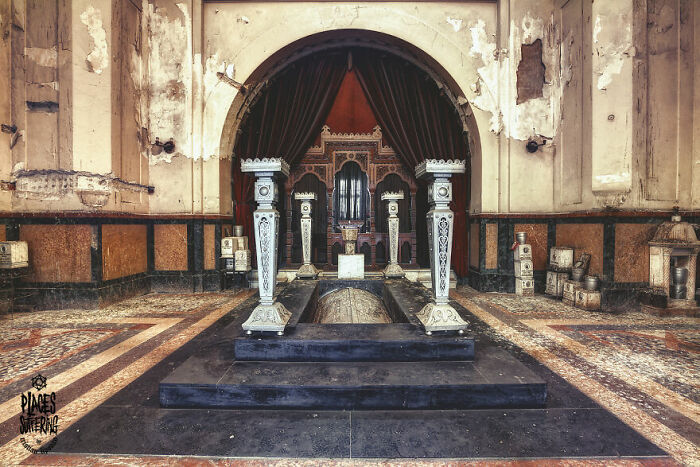 Abandoned place with ornate pillars and peeling walls, showcasing a haunting yet beautiful atmosphere.