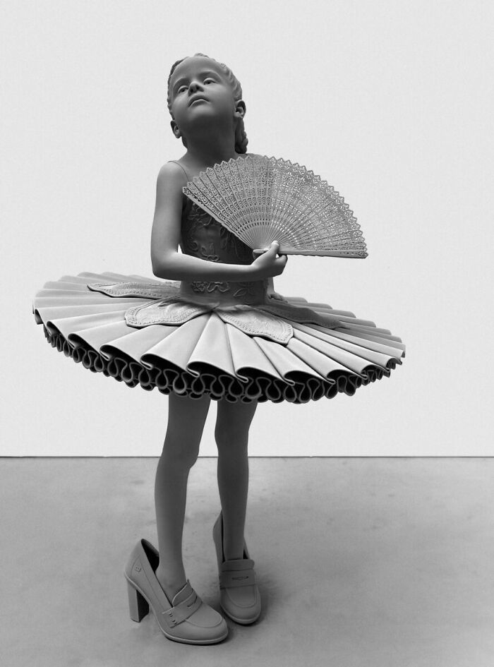 Monochrome sculpture by Hans Op De Beeck showing a young girl in a tutu holding a fan.
