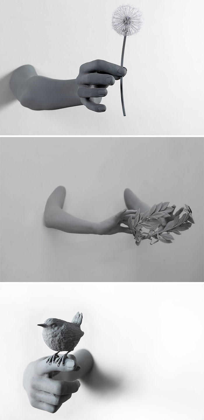 Monochrome sculptures by Hans Op De Beeck depicting hands holding a dandelion, laurel, and bird.