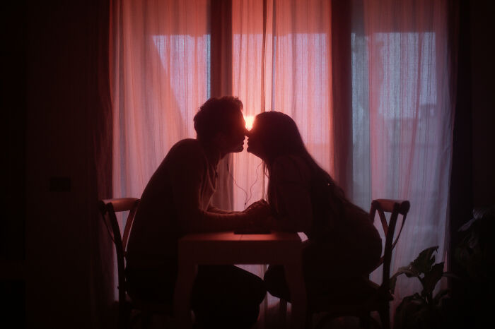 Silhouetted couple kissing in front of sunset, creating one of the best engagement photos of 2025.
