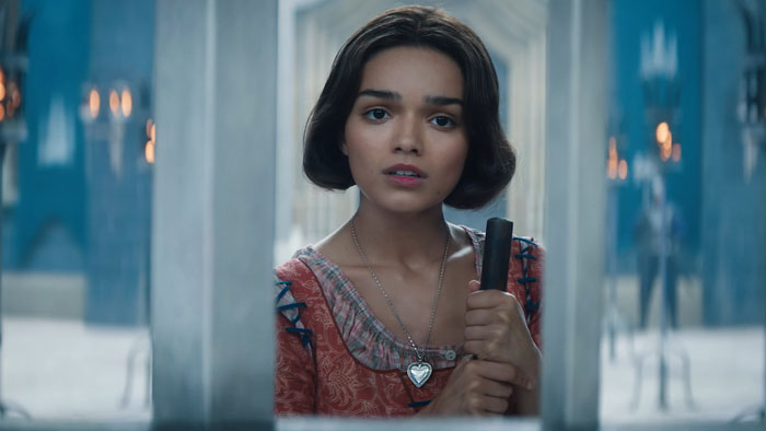 Young woman in colorful dress holds a metal bar, representing changes in new Snow White remake.