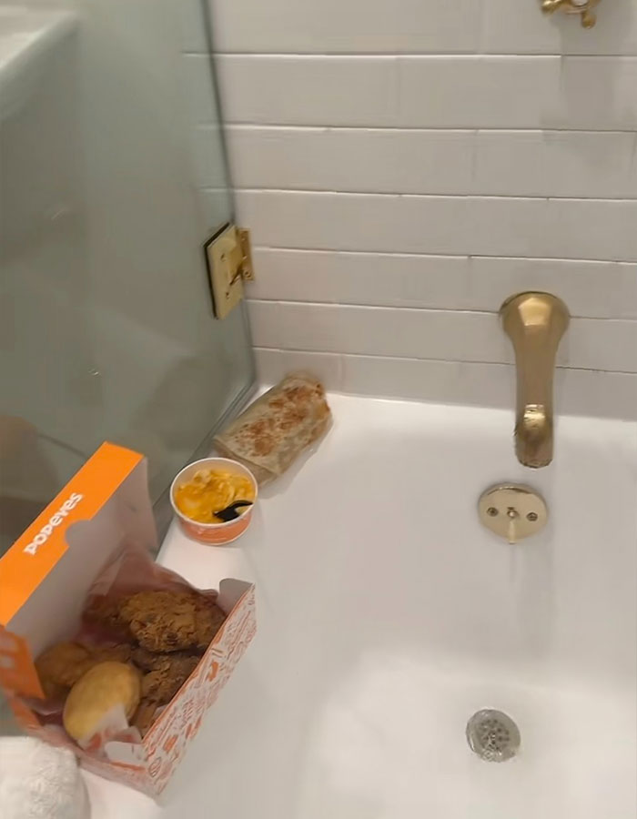 Bathroom scene with shower containing fast food, reflecting Benny Blanco's unusual shower habits.