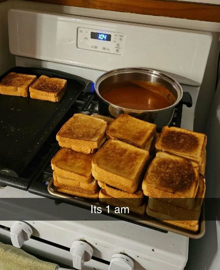 A chaotic pile of toasted sandwiches at 1 am on a stove, embodying unhinged food chaos.