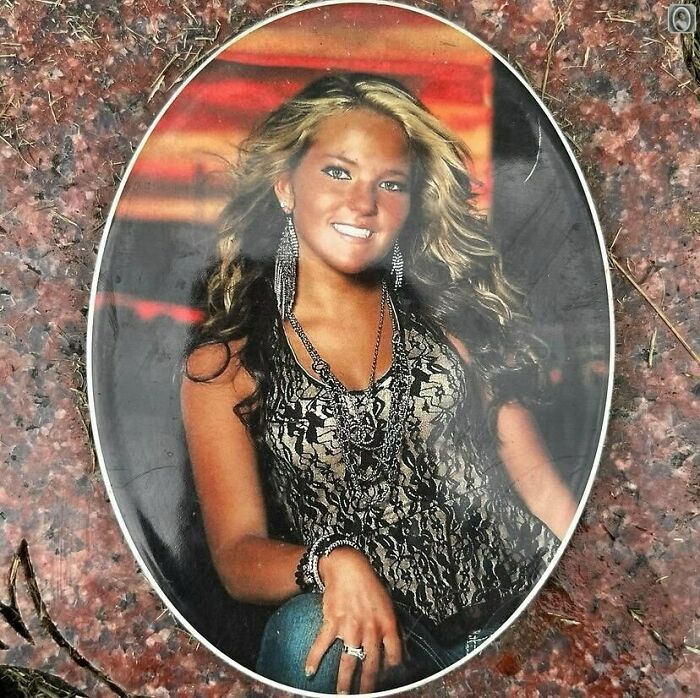 Lovely headstone portrait featuring a smiling woman with long hair and jewelry, set against a colorful background.