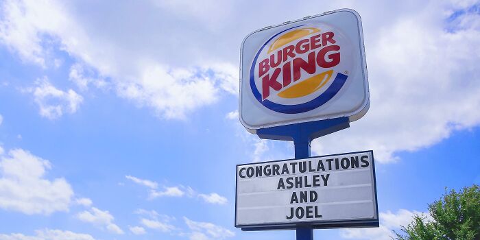 Burger King sign with "Congratulations Ashley and Joel," showcasing random facts about the world.