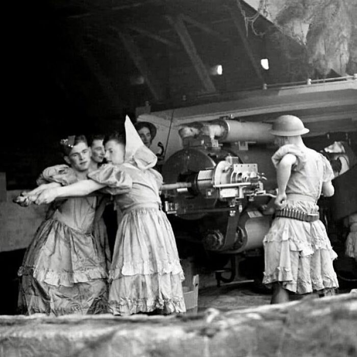 Historical soldiers in dresses operating artillery, showcasing a unique moment from the past.