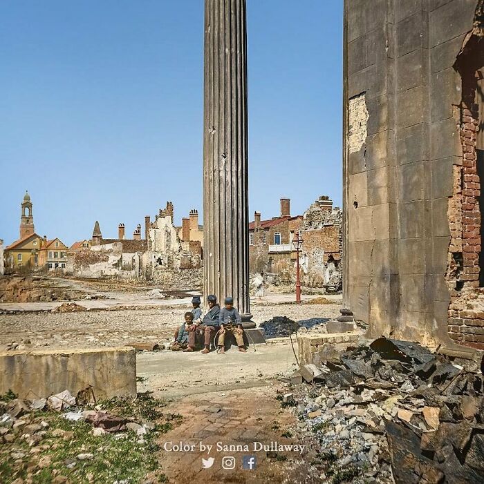 Children sitting by a column amidst historical ruins, illustrating the past.