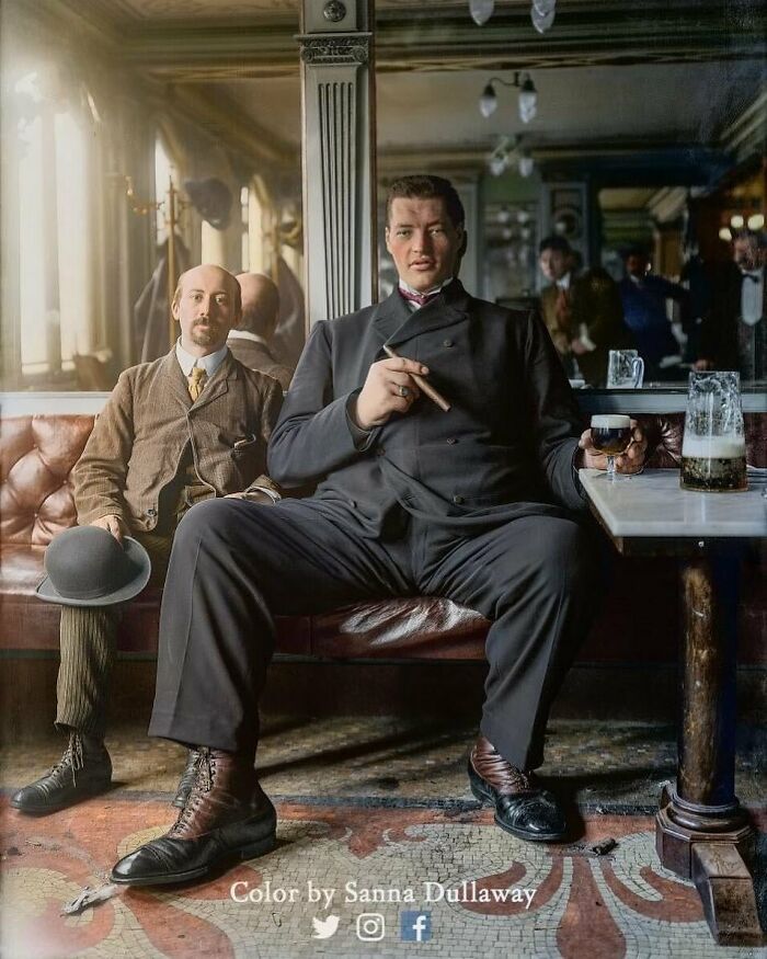 Two historical men in a vintage bar, one holding a cigar and drink, capturing a moment from the past.
