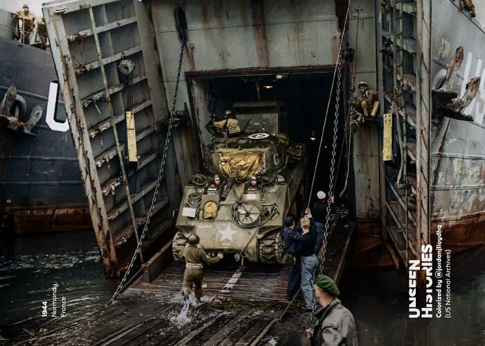 World War II tank disembarking landing craft at Normandy, France, capturing a significant historical moment.