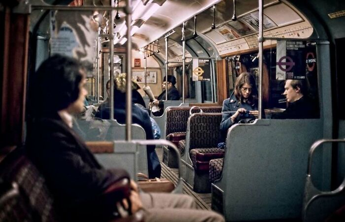 Passengers in a vintage subway car, capturing a moment of historical nostalgia.