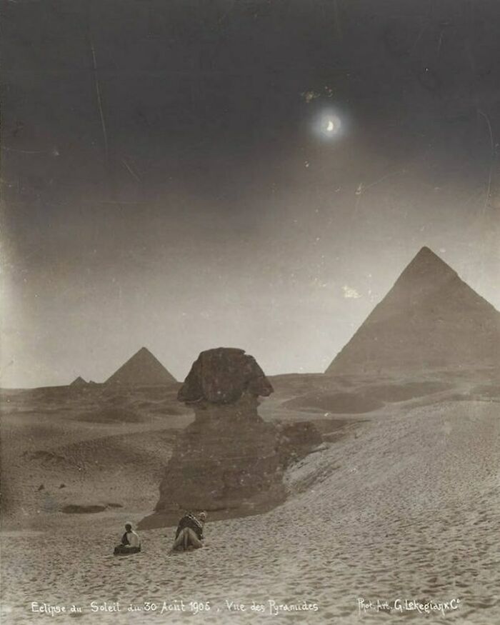 Historical photo of the pyramids and Sphinx under a solar eclipse, 1905, evoking nostalgia.