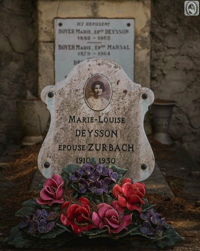 Headstone portrait of Marie-Louise Deysson with engraved details and colorful flower arrangement.