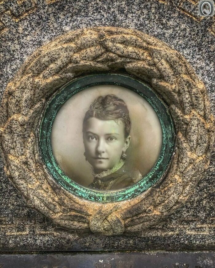 Lovely headstone portrait of a young woman framed in an ornate circular design on a stone monument.