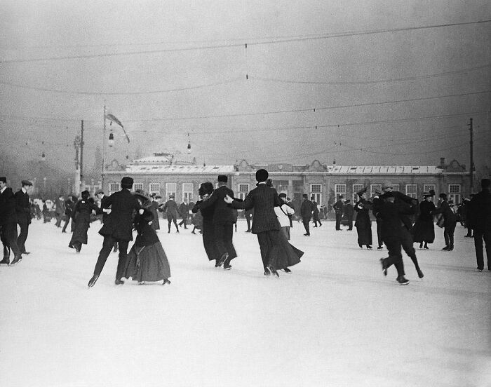 Historical ice skating scene with elegantly dressed couples, adding nostalgia.