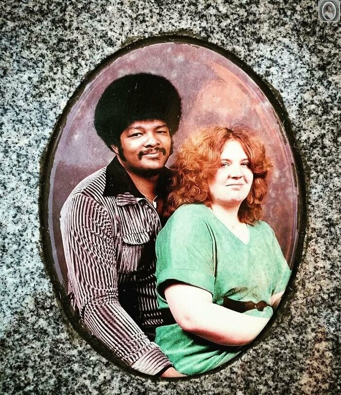 A couple from the past sits together on a headstone portrait, symbolizing their lasting bond.