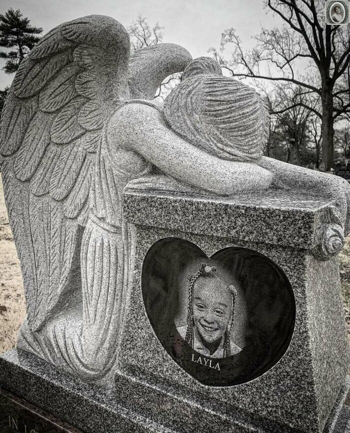 Angel statue with headstone portrait of girl named Layla, capturing a lovely memorial tribute in a cemetery.