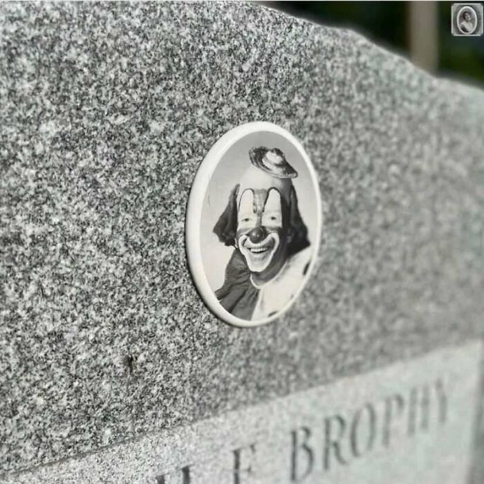 Portrait of a clown on a headstone, capturing an interesting and lovely memorial moment.