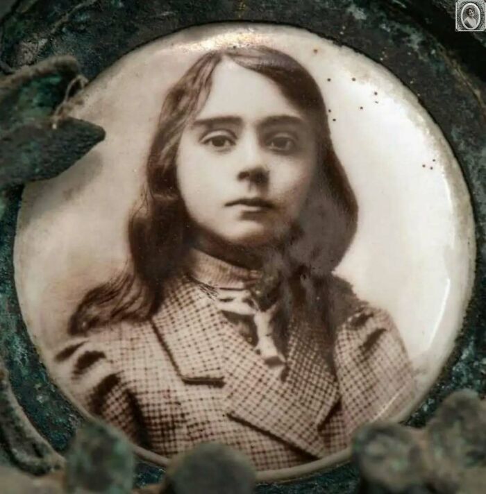 Lovely headstone portrait of a young girl with long hair, in a vintage attire, showcasing a serene expression.