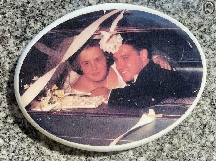 A lovely headstone portrait of a smiling couple on their wedding day inside a car adorned with ribbons.