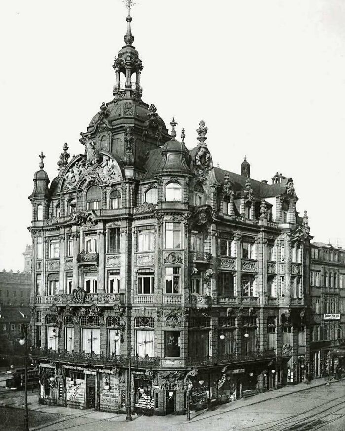 Elaborate old American architecture building with ornate facade and multiple windows on a street corner.