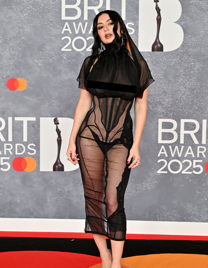 Woman in sheer black dress at 2025 BRIT Awards, sparking cultural moment around "classless" bush debate.
