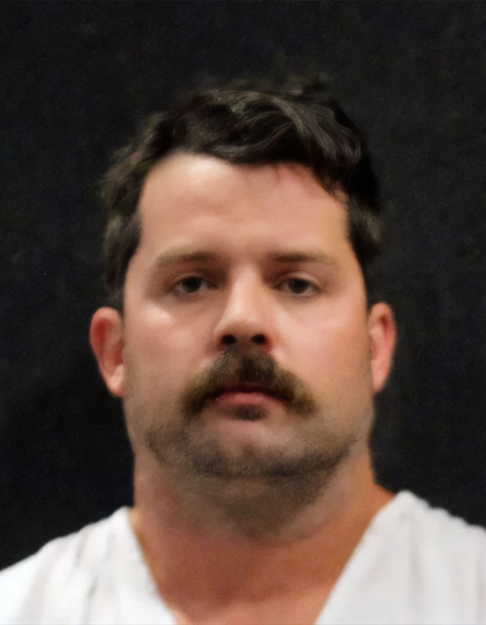 Man with dark hair and mustache against a dark background, related to plea deal rejection case.
