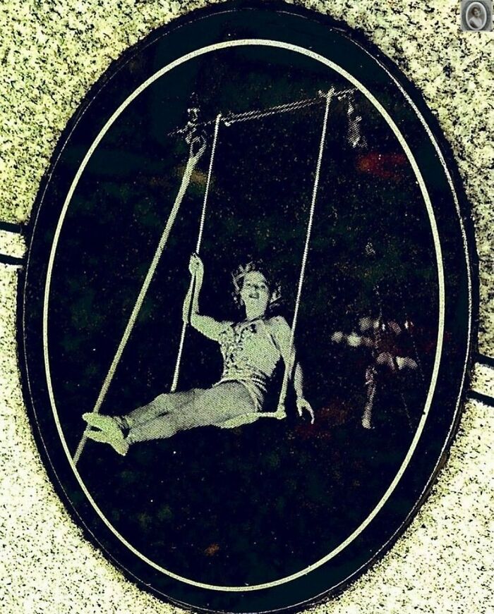 A lovely headstone portrait shows a woman joyfully swinging, captured in a vintage-style oval frame.