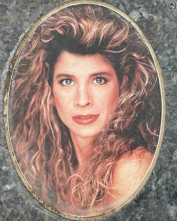Portrait of a woman with curly hair on a headstone, showcasing a lovely and timeless memorial style.