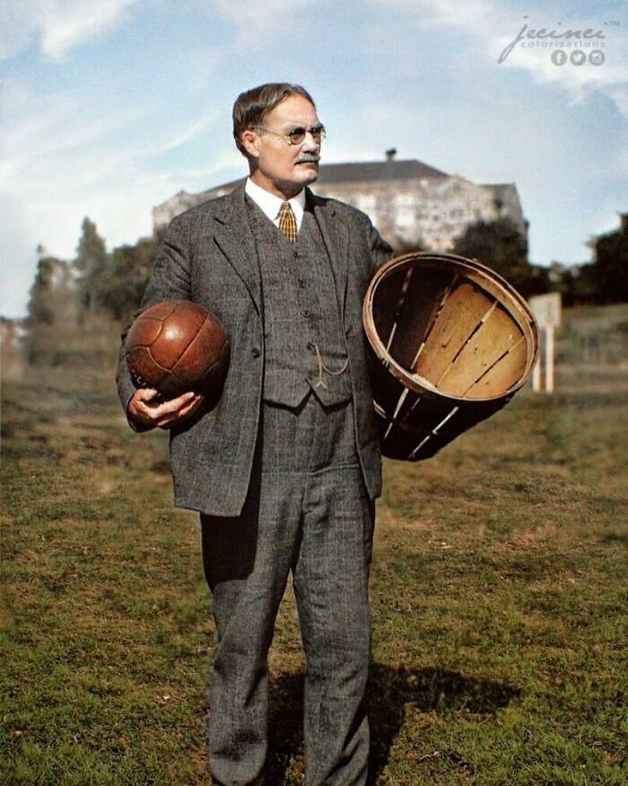 Man in vintage suit holding early basketball and hoop, illustrating historical sports development.