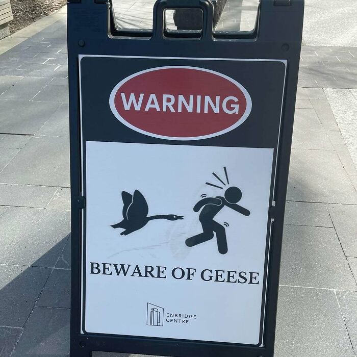 Warning sign at Enbridge Centre, Canada, showing a stick figure chased by a goose.