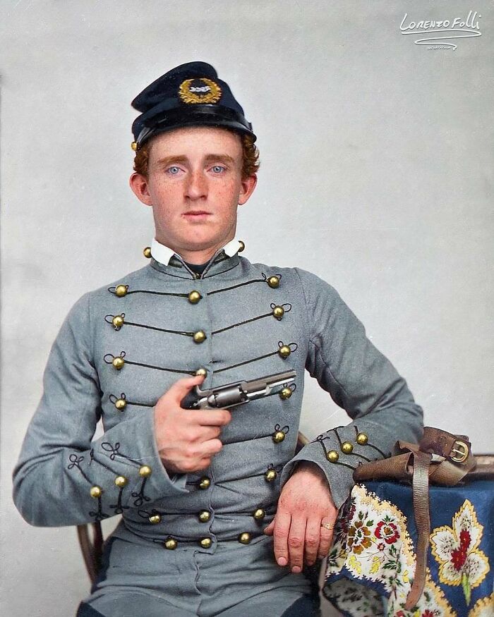 Young soldier in historical uniform, holding a pistol, exemplifying historical moments from the past.