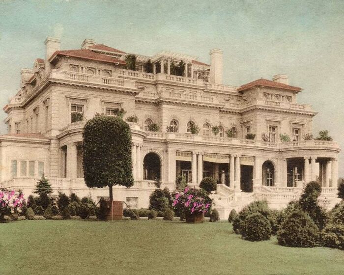 Elegant old American architecture with grand columns and manicured gardens in the foreground.