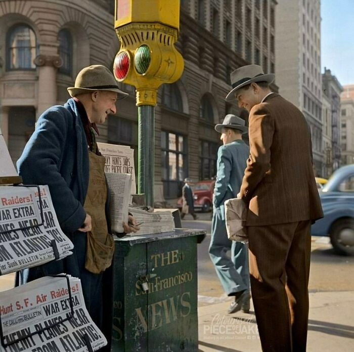 Two men in 1940s attire at a San Francisco newsstand, engaging with historical newspapers.
