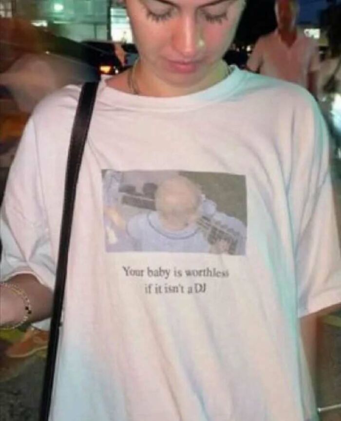 Person wearing a chaotic T-shirt with humorous DJ baby print.