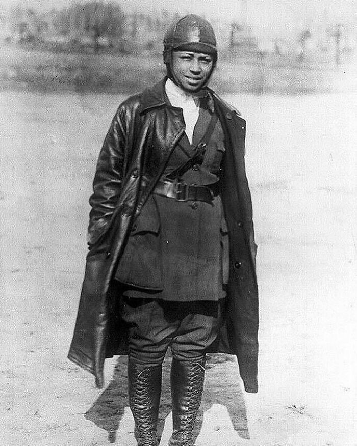 Historical photo of a pilot in a leather jacket and helmet, representing a significant moment from the past.