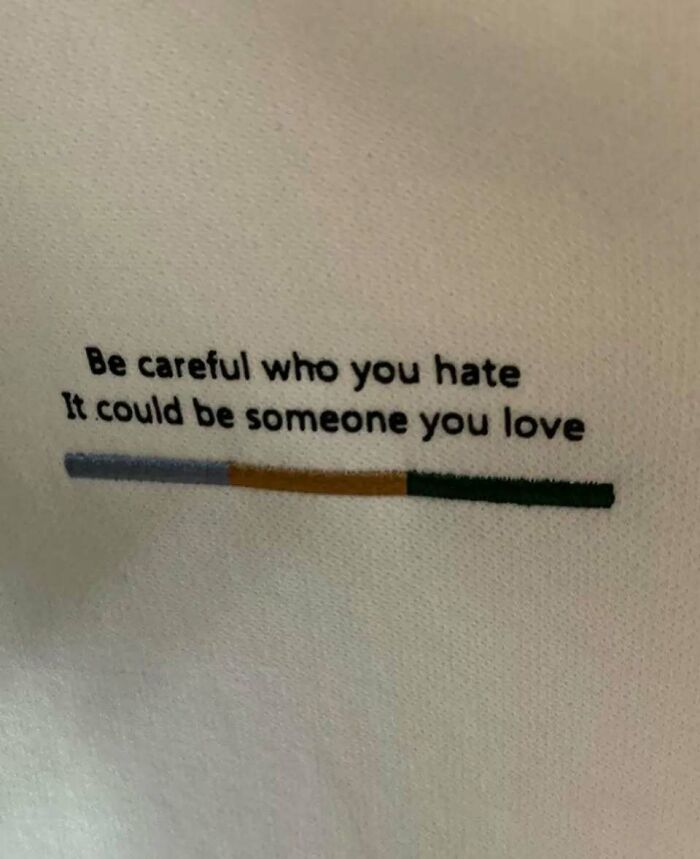 T-shirt with quote "Be careful who you hate, it could be someone you love," showcasing chaotic truth.