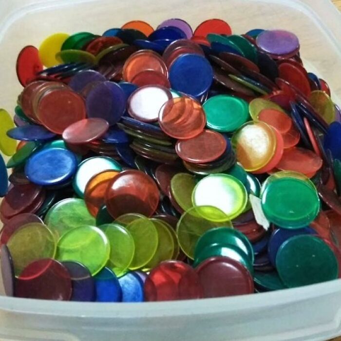 Colorful transparent bingo chips in a container, evoking nostalgic throwbacks for those familiar with floppy disks.