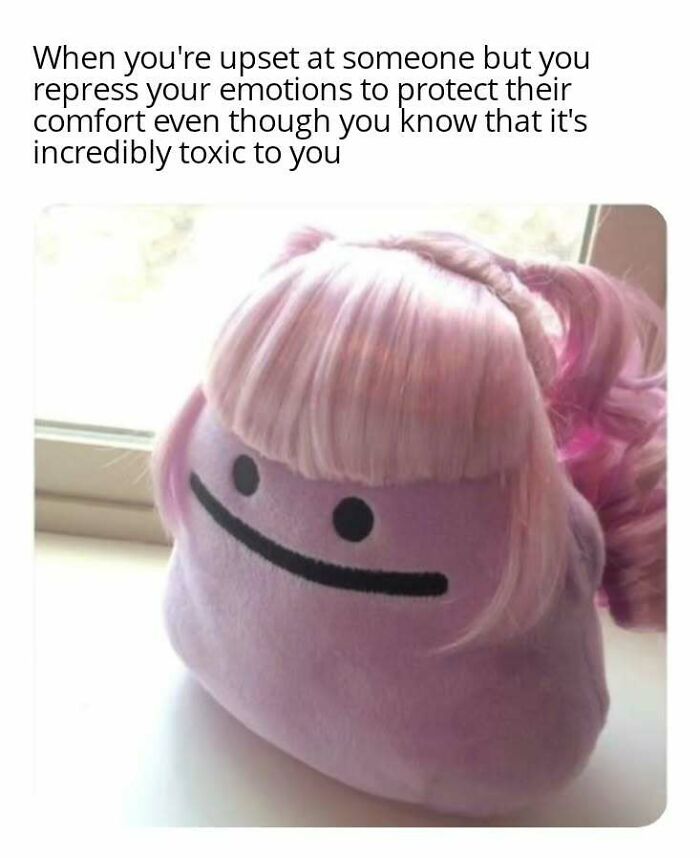 Purple plush toy with a straight face and pink wig, capturing introvert emotions from "Diary Introverts" memes.