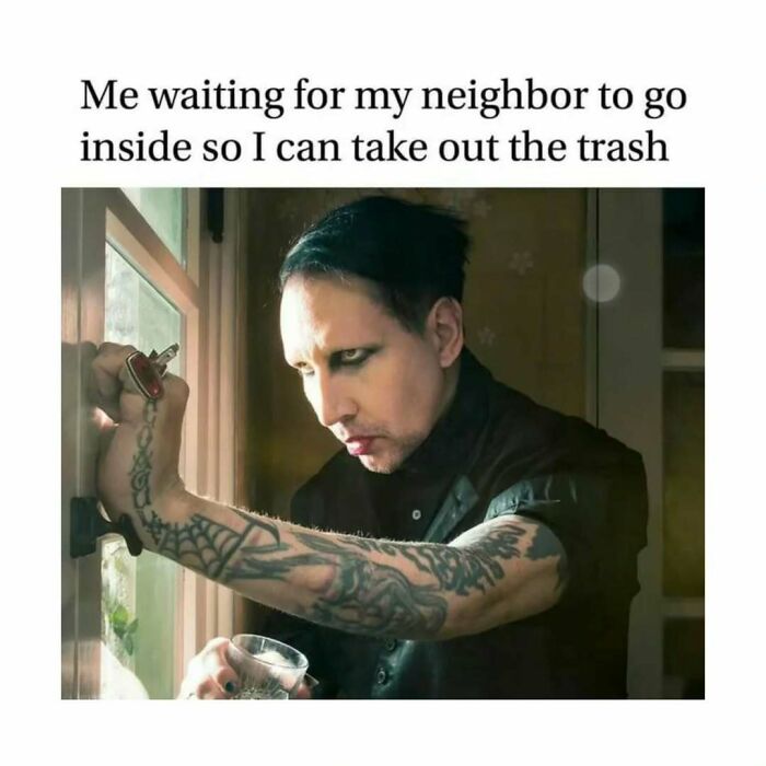 Tattooed person peering through a window, humorously with a glass, depicted in an amusing introvert meme.