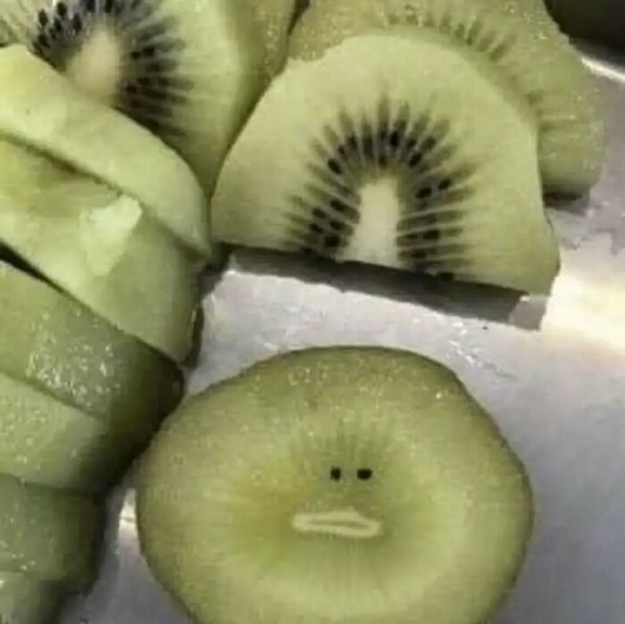 Slices of kiwi with a surprised expression, showcasing chaotic food humor.