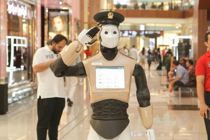 Robot cop saluting in Dubai mall, showcasing futuristic technology unique to Dubai.