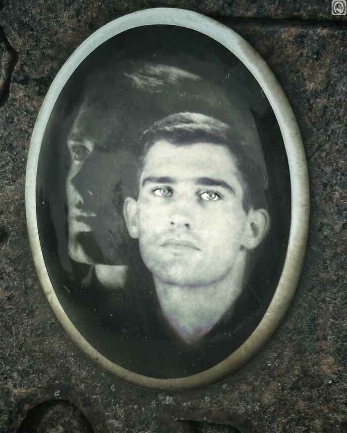 Vintage headstone portrait of a young man with a dual exposure effect on a textured stone background.