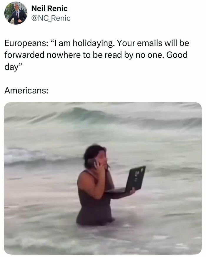 Person standing in the ocean, using a laptop and phone. Middle class fancy meme humor.