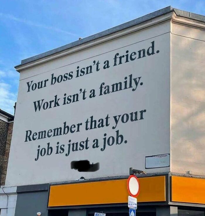 Wall mural with job meme: "Your job is just a job," emphasizing a realistic work perspective.