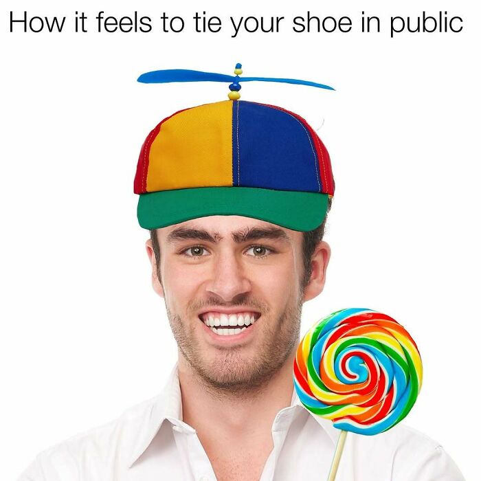 Man in a colorful hat holding a lollipop, embodying Middle Class Fancy humor.
