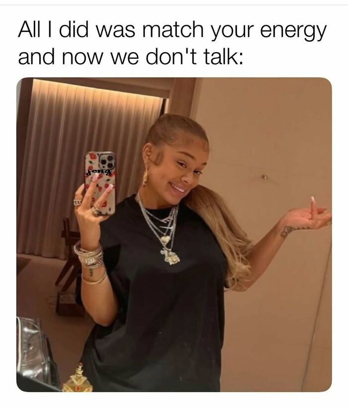 Woman smiling in a mirror selfie, holding up her hand humorously. Text about matching energy not leading to conversations.