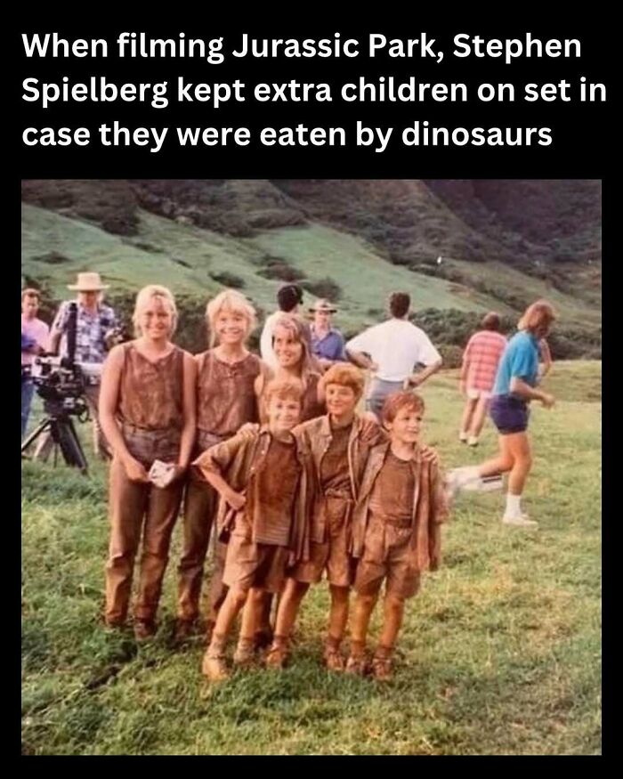 Cast in muddy costumes, standing on Jurassic Park set, evoking funny throwbacks for floppy disk era fans.